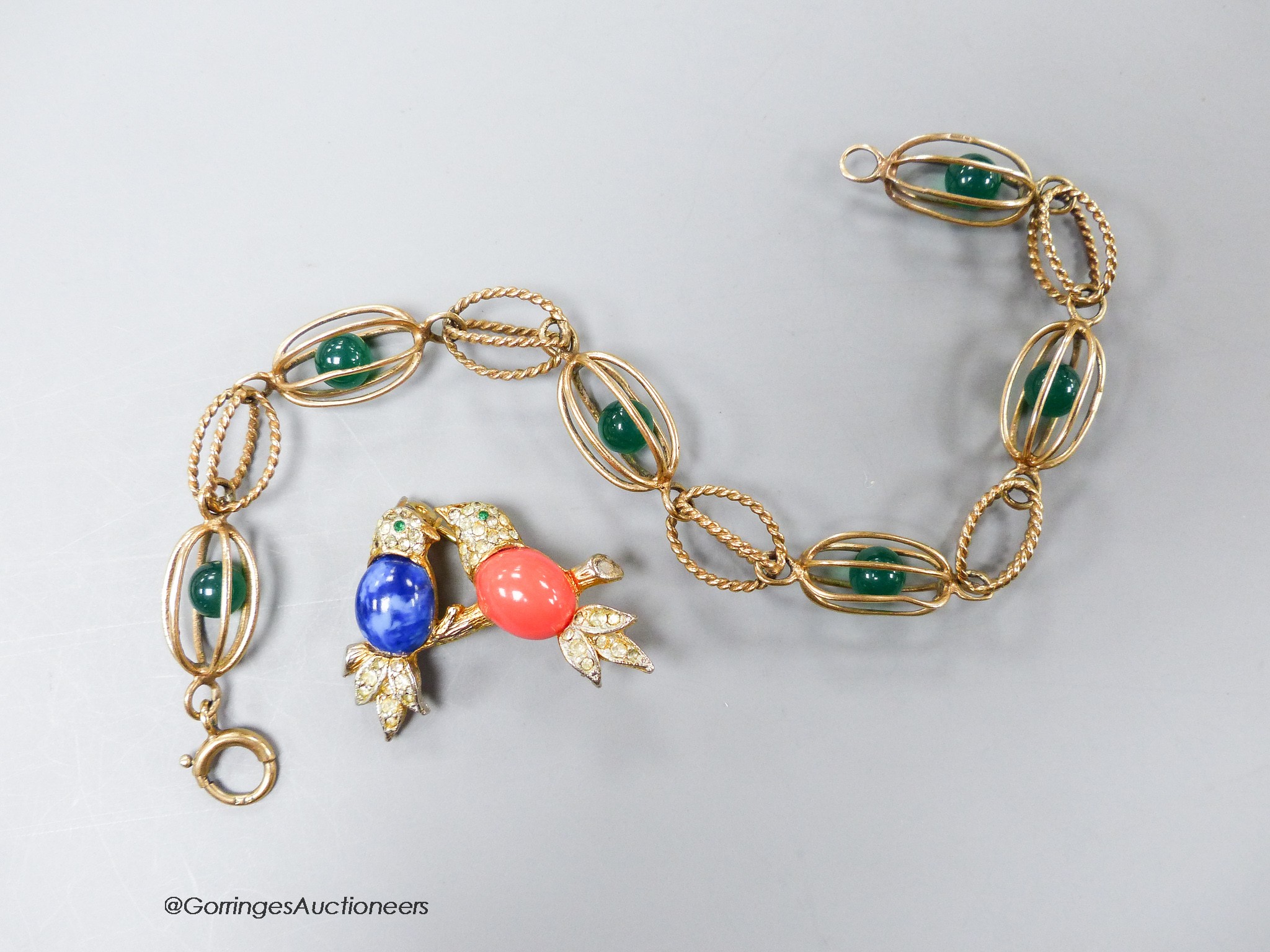 A yellow metal and caged chrysoprase bead bracelet, 18.5cm, gross 8 grams and a costume brooch.